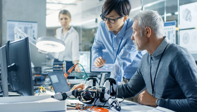 Two design engineers comparing material options online.